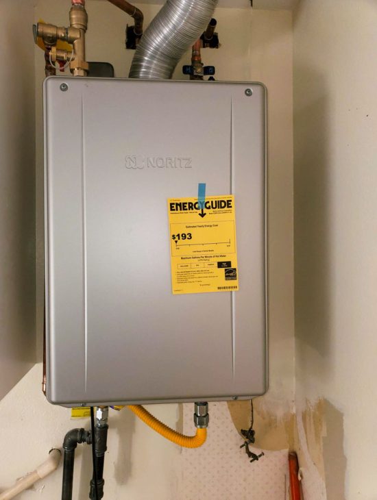 Energy Efficient Wall-Mounted Gas Heater Wall-mounted energy-efficient gas heater with an attached energy guide sticker, emphasizing sustainable home heating solutions.