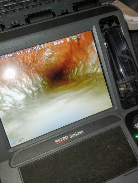 Advanced Plumbing Inspection Technology Close-up of a RIDGID SeeSnake monitor displaying the interior of a pipe, used for detailed plumbing inspections.