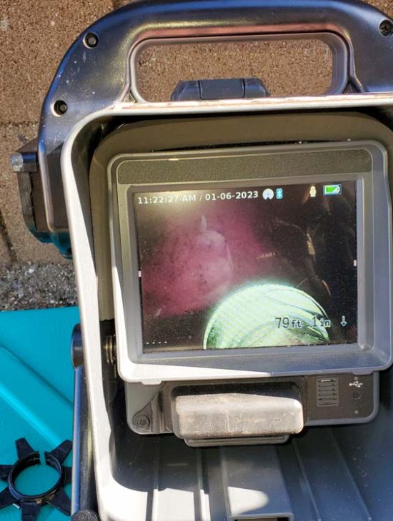 Sewer Line Inspection Using Digital Monitor A digital monitor displaying the interior view of a sewer line during an inspection.